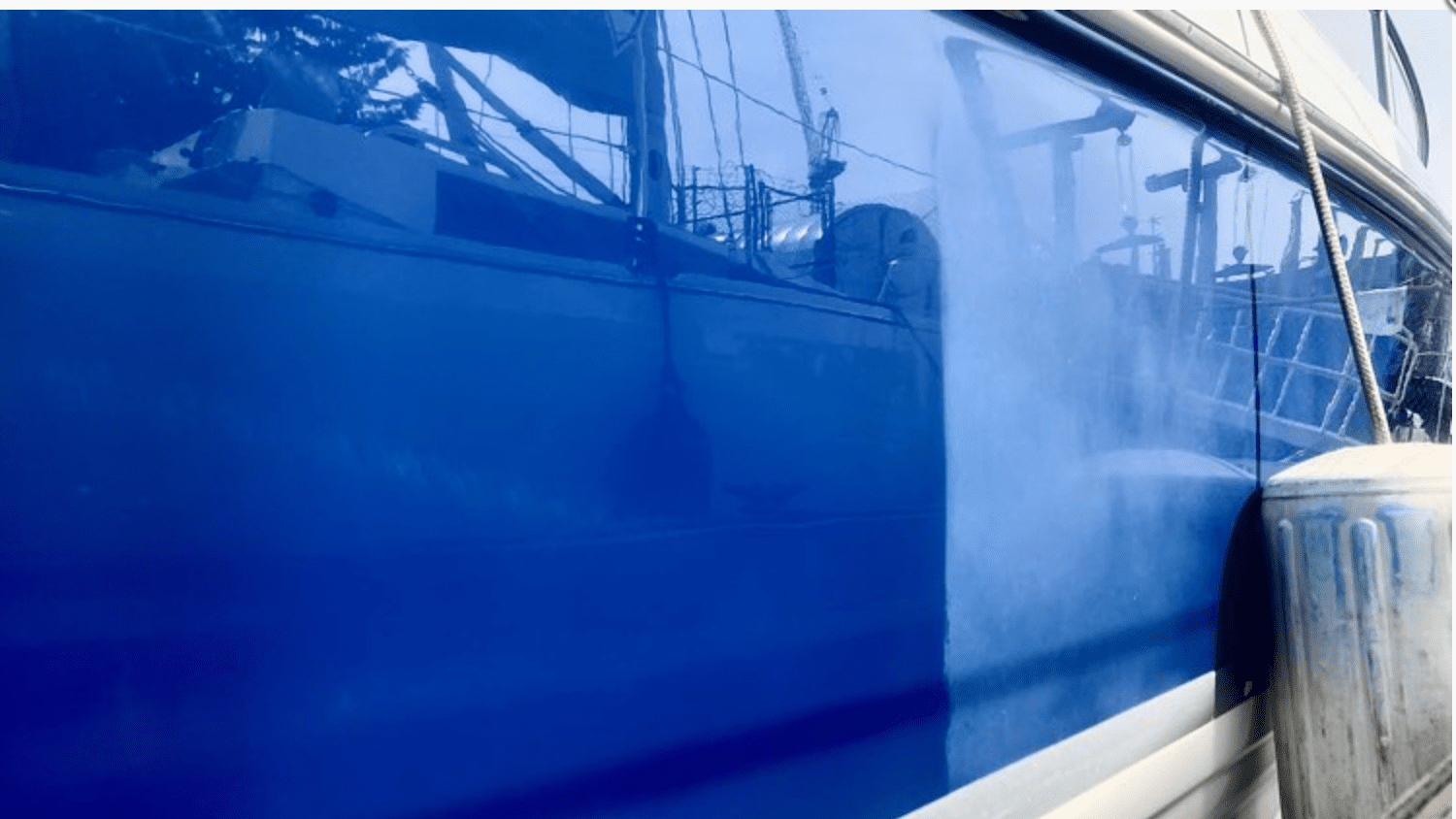 A blue boat is reflected in the mirror.